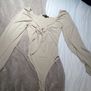 Taupe, small, balloon sleeve cutout bodysuit. Slight stain on back of right arm.